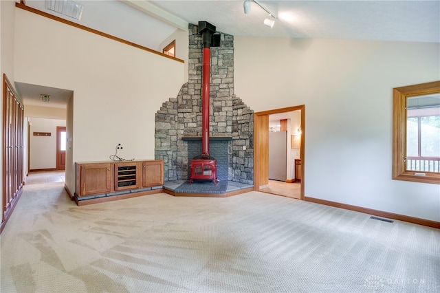 4911 Arabian Dr, Fairborn, OH 45324 - unfurnished living room with a wood stove, light carpet, high vaulted ceiling, beamed ceiling, and wine cooler