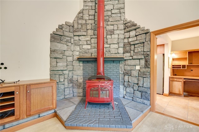 4911 Arabian Dr, Fairborn, OH 45324 - detailed view of stainless steel dishwasher, a wood stove, and freestanding refrigerator