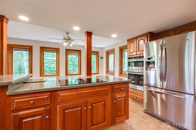 4911 Arabian Dr, Fairborn, OH 45324 - kitchen featuring appliances with stainless steel finishes, brown cabinetry, healthy amount of natural light, and recessed lighting