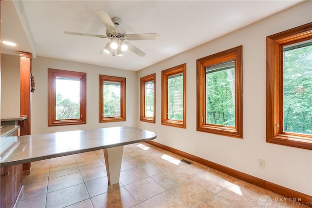 4911 Arabian Dr, Fairborn, OH 45324 - unfurnished dining area with plenty of natural light, a ceiling fan, and light tile patterned floors