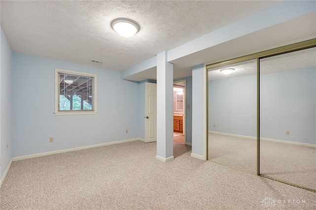 4911 Arabian Dr, Fairborn, OH 45324 - below grade area with a textured ceiling and carpet