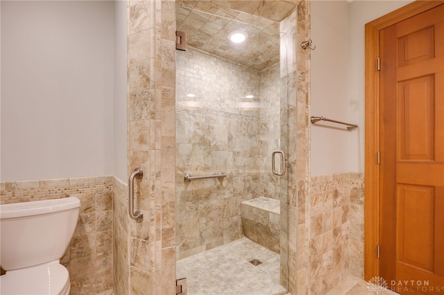 4911 Arabian Dr, Fairborn, OH 45324 - bathroom featuring a shower stall, wainscoting, and tile walls