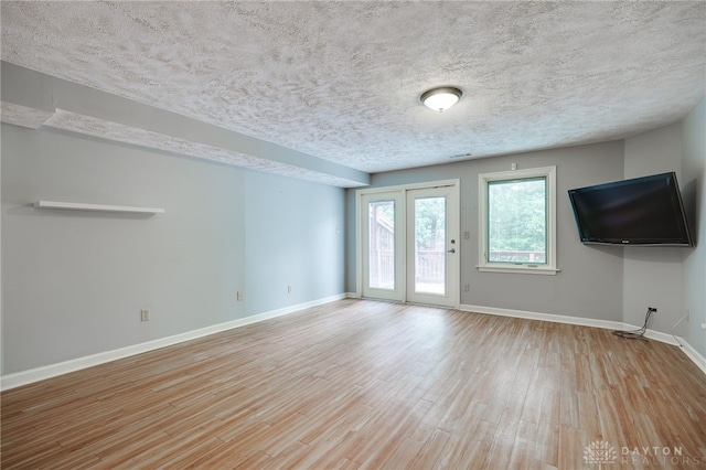 4911 Arabian Dr, Fairborn, OH 45324 - unfurnished living room with wood finished floors and a textured ceiling