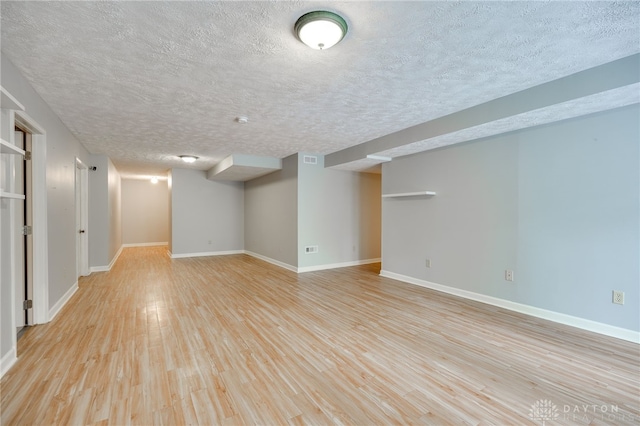4911 Arabian Dr, Fairborn, OH 45324 - finished basement with light wood-style floors and a textured ceiling