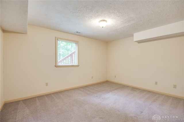4911 Arabian Dr, Fairborn, OH 45324 - spare room featuring light carpet and a textured ceiling
