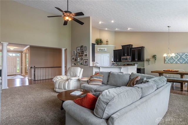 8695 Dijon Ct, Washington Twp, OH 45458 - carpeted living area with high vaulted ceiling, a textured ceiling, ceiling fan, a chandelier, and wood finished floors