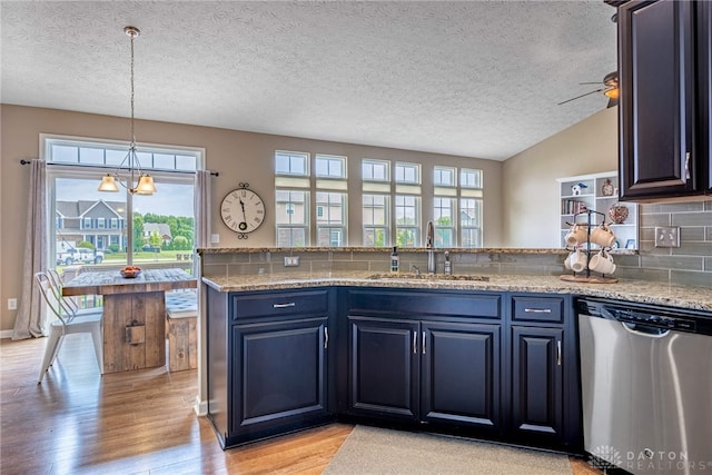 8695 Dijon Ct, Washington Twp, OH 45458 - kitchen with stainless steel dishwasher, light wood-type flooring, a textured ceiling, tasteful backsplash, and blue cabinetry