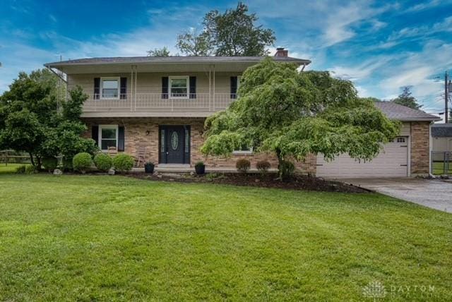 116 Whisman Dr, Middletown, OH 45042 - view of front of property featuring a balcony, concrete driveway, a front yard, and a garage