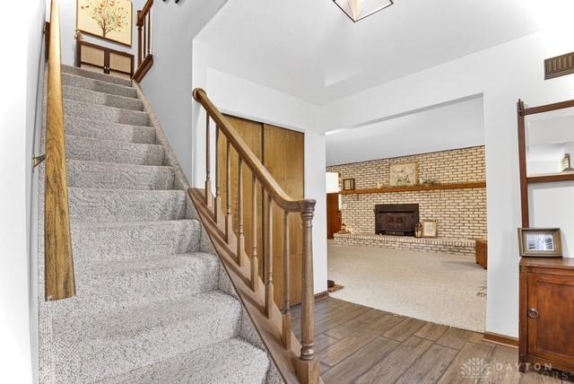 116 Whisman Dr, Middletown, OH 45042 - stairs with wood finished floors and a fireplace