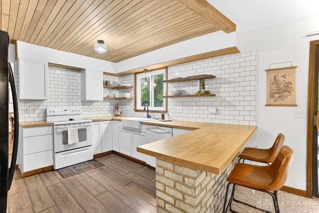116 Whisman Dr, Middletown, OH 45042 - kitchen with white appliances, open shelves, decorative backsplash, a peninsula, and wood ceiling