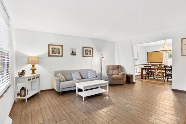116 Whisman Dr, Middletown, OH 45042 - living area featuring wood finished floors, plenty of natural light, and a chandelier