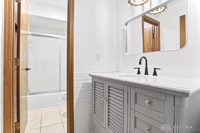 116 Whisman Dr, Middletown, OH 45042 - full bath featuring vanity, wainscoting, shower / bath combination with glass door, and tile patterned flooring