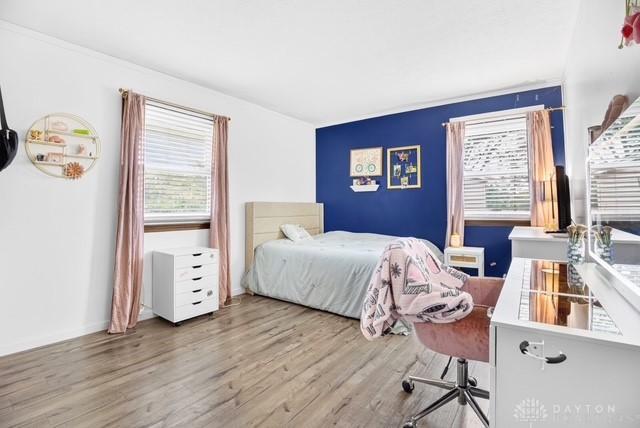 116 Whisman Dr, Middletown, OH 45042 - bedroom featuring wood finished floors, multiple windows, and a desk