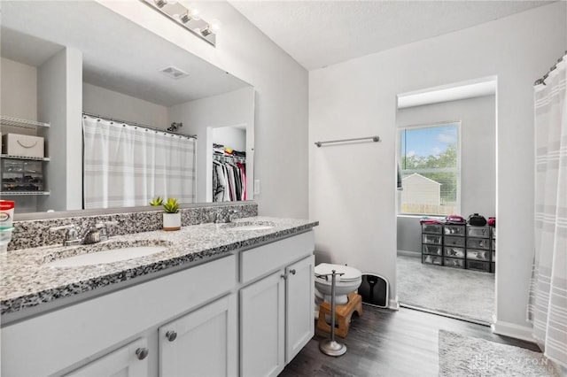 805 Marshall Dr, Xenia, OH 45385 - full bathroom with wood finished floors, double vanity, and a walk in closet