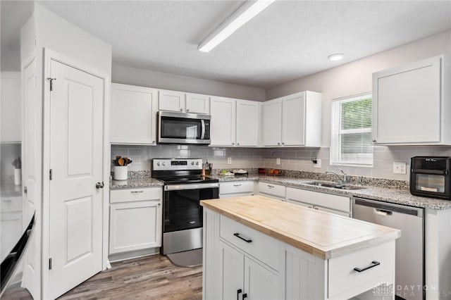 805 Marshall Dr, Xenia, OH 45385 - kitchen featuring stainless steel appliances, wooden counters, backsplash, and white cabinets