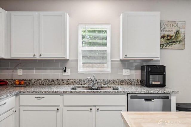 805 Marshall Dr, Xenia, OH 45385 - kitchen featuring dishwasher, white cabinetry, decorative backsplash, and light stone counters