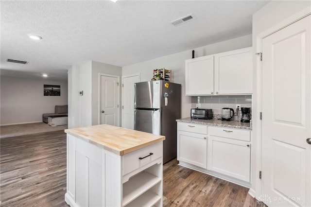805 Marshall Dr, Xenia, OH 45385 - kitchen featuring freestanding refrigerator, white cabinetry, wood finished floors, butcher block counters, and recessed lighting