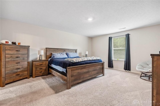 805 Marshall Dr, Xenia, OH 45385 - carpeted bedroom featuring a textured ceiling and baseboards