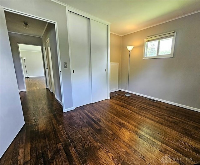 2224 Vale Dr, Kettering, OH 45420 - unfurnished bedroom with ornamental molding, wood-type flooring, and a closet