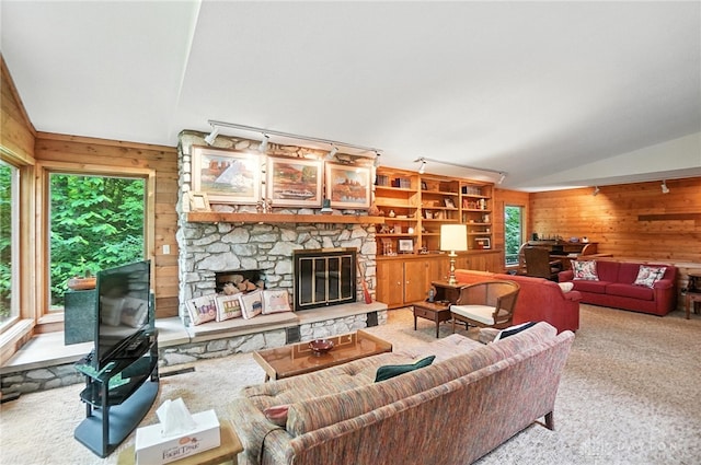 1917 Antrim Ct, Middletown, OH 45042 - living room with wooden walls, lofted ceiling, a stone fireplace, and carpet flooring