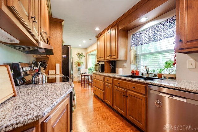 4930 Wildoak Ct, Dayton, OH 45424 - kitchen with stainless steel dishwasher, range with electric stovetop, light wood finished floors, under cabinet range hood, and healthy amount of natural light