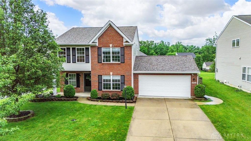 2945 Kant Pl, Beavercreek, OH 45431 - view of front facade with brick siding, a garage, a front yard, a shingled roof, and driveway