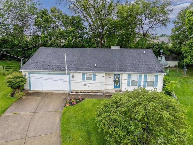 995 Wren Ct, Monroe, OH 45050 - view of front facade with concrete driveway, an attached garage, a shingled roof, and a chimney