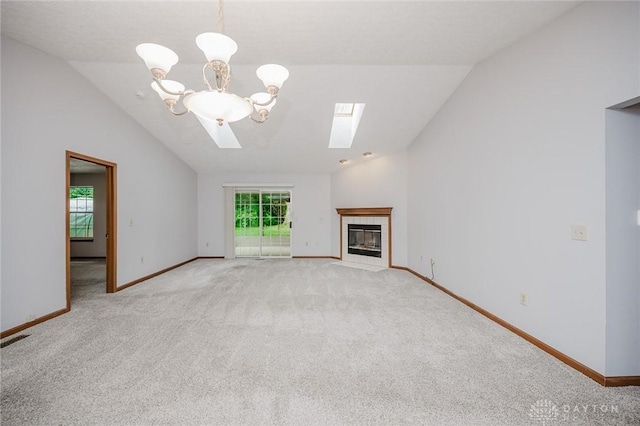 995 Wren Ct, Monroe, OH 45050 - unfurnished living room featuring lofted ceiling, a skylight, light colored carpet, a chandelier, and a fireplace