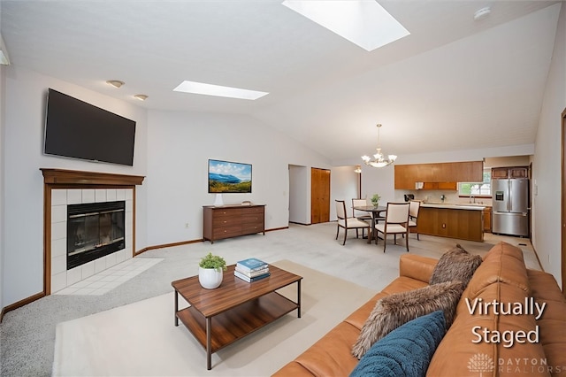 995 Wren Ct, Monroe, OH 45050 - living area with a skylight, a chandelier, vaulted ceiling, and light carpet