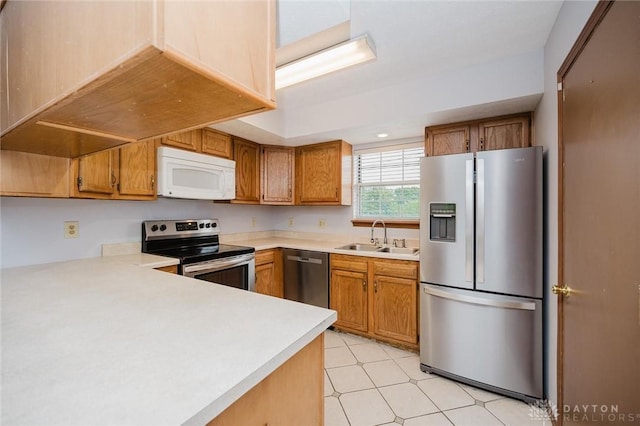 995 Wren Ct, Monroe, OH 45050 - kitchen with stainless steel appliances, light countertops, brown cabinets, and light flooring