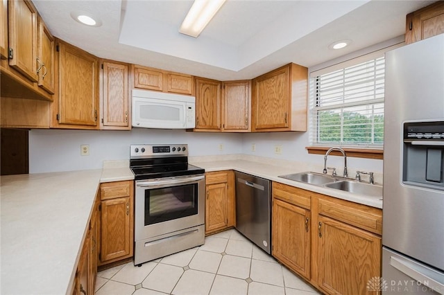 995 Wren Ct, Monroe, OH 45050 - kitchen featuring appliances with stainless steel finishes, light countertops, brown cabinetry, and recessed lighting