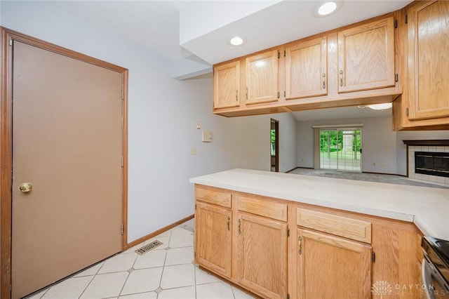 995 Wren Ct, Monroe, OH 45050 - kitchen with stainless steel stove, light countertops, light brown cabinets, recessed lighting, and a peninsula