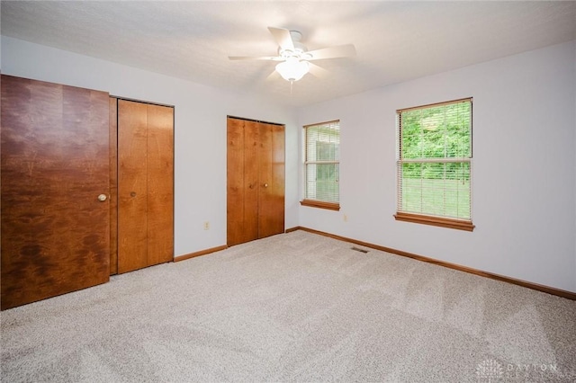 995 Wren Ct, Monroe, OH 45050 - unfurnished bedroom featuring multiple closets, carpet flooring, and ceiling fan
