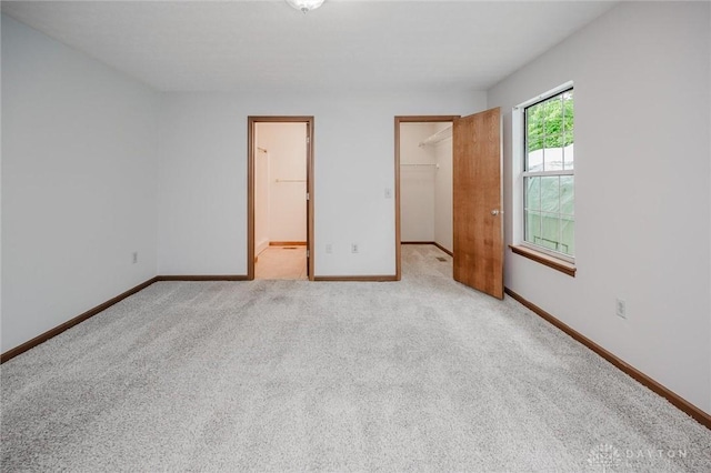 995 Wren Ct, Monroe, OH 45050 - unfurnished bedroom featuring a walk in closet, carpet, a closet, and ensuite bathroom
