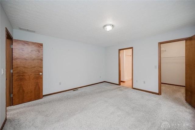 995 Wren Ct, Monroe, OH 45050 - unfurnished bedroom with carpet, a walk in closet, and a closet