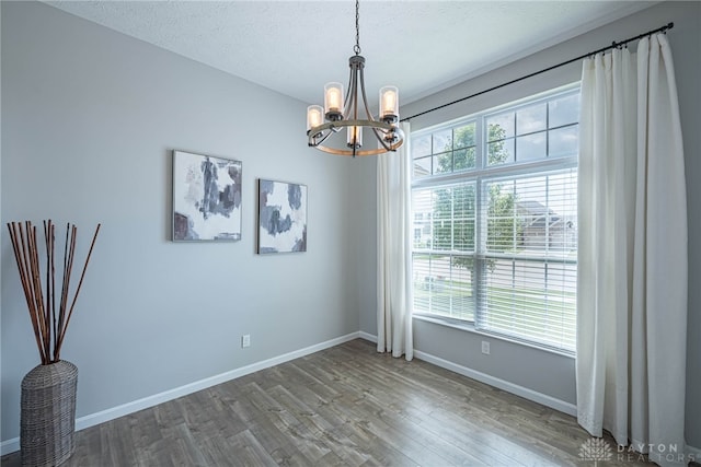 1693 Sunset Canyon Ct, Fairborn, OH 45324 - unfurnished room with a chandelier and wood finished floors