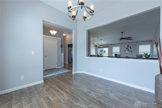 1693 Sunset Canyon Ct, Fairborn, OH 45324 - unfurnished living room featuring a chandelier, wood finished floors, and a ceiling fan