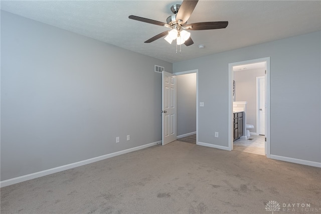 1693 Sunset Canyon Ct, Fairborn, OH 45324 - unfurnished bedroom with light colored carpet, connected bathroom, and ceiling fan