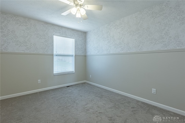 1693 Sunset Canyon Ct, Fairborn, OH 45324 - carpeted spare room featuring wallpapered walls, a textured ceiling, and ceiling fan