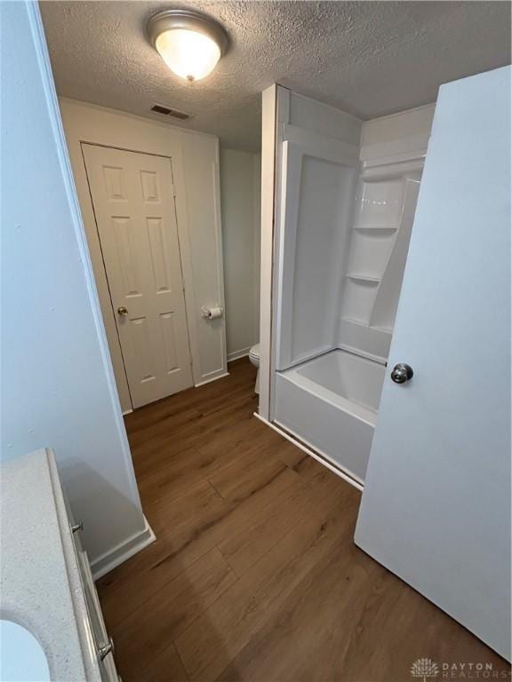 18 E Xenia St, Jamestown Vlg, OH 45335 - bathroom with wood finished floors, a textured ceiling, and shower / bath combination