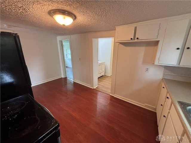 18 E Xenia St, Jamestown Vlg, OH 45335 - kitchen featuring electric range, dark wood-type flooring, white cabinets, light countertops, and a textured ceiling