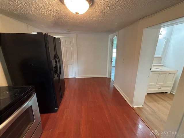18 E Xenia St, Jamestown Vlg, OH 45335 - kitchen with electric stove, dark wood-style floors, a textured ceiling, and light countertops