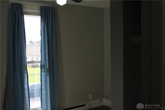 302 W 1st St, Arcanum, OH 45304 - empty room with baseboard heating and ceiling fan