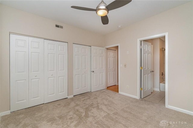 964 Auburnview Dr Unit 3E, Cincinnati, OH 45206 - unfurnished bedroom featuring multiple closets, carpet, connected bathroom, and a ceiling fan