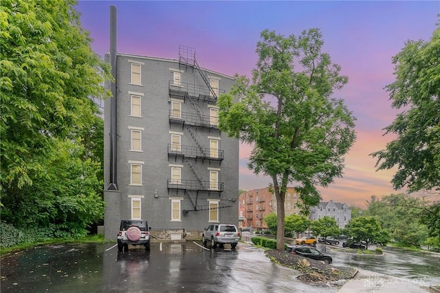 964 Auburnview Dr Unit 3E, Cincinnati, OH 45206 - property at dusk with uncovered parking and a view of apartment building / complex