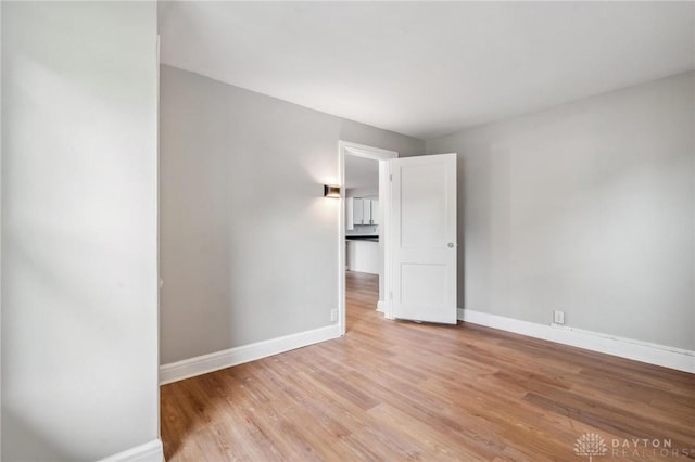 610 N Spring St, Wilmington, OH 45177 - empty room with baseboards and light wood-style flooring