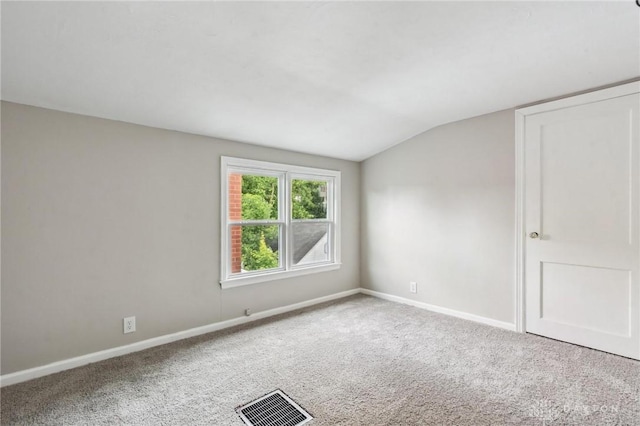 610 N Spring St, Wilmington, OH 45177 - carpeted empty room with vaulted ceiling and baseboards