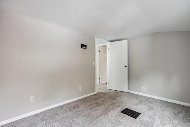 610 N Spring St, Wilmington, OH 45177 - empty room with carpet flooring and vaulted ceiling