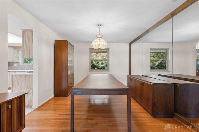1620 Ambridge Rd, Dayton, OH 45459 - kitchen featuring light wood-type flooring, hanging light fixtures, a chandelier, and light countertops