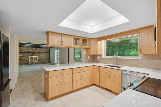 1620 Ambridge Rd, Dayton, OH 45459 - kitchen with light brown cabinets, appliances with stainless steel finishes, a peninsula, light countertops, and brick wall